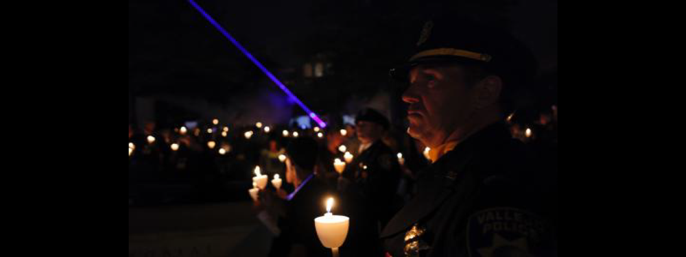 A group of people holding candles in the dark.