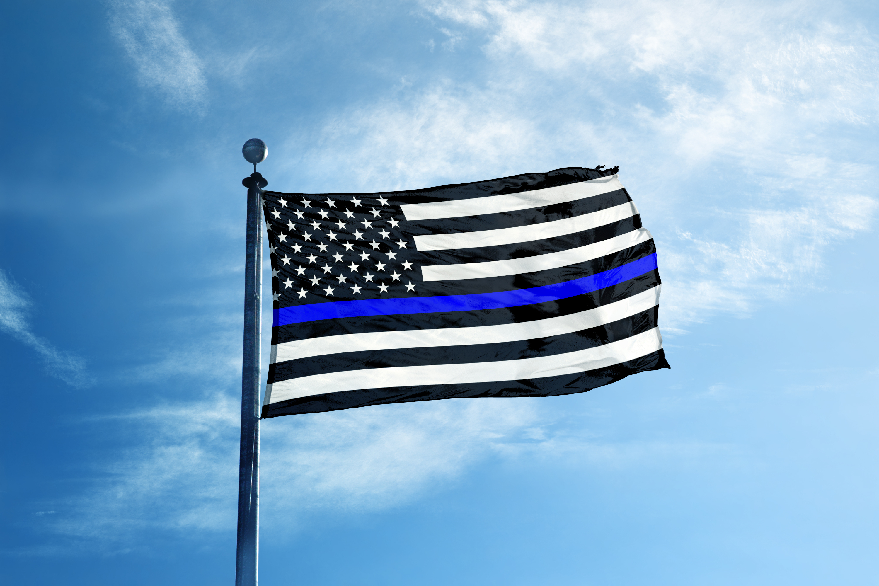 A flag with the american flag and blue line on it.